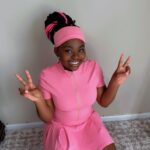 Pink three-piece skirt set with zip-front crop top and biker shorts