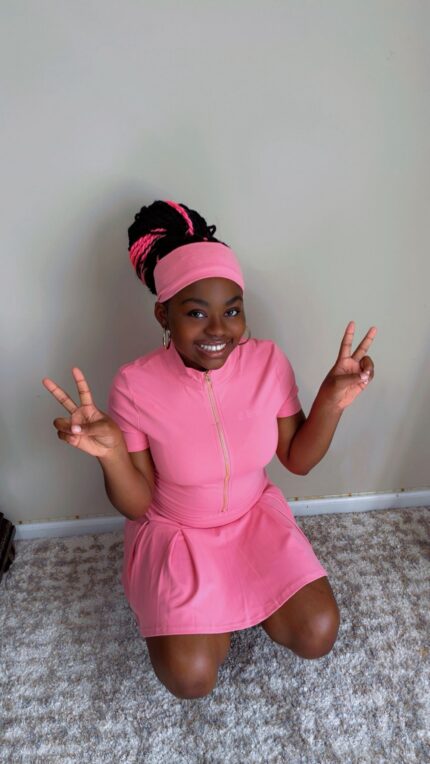 Pink three-piece skirt set with zip-front crop top and biker shorts